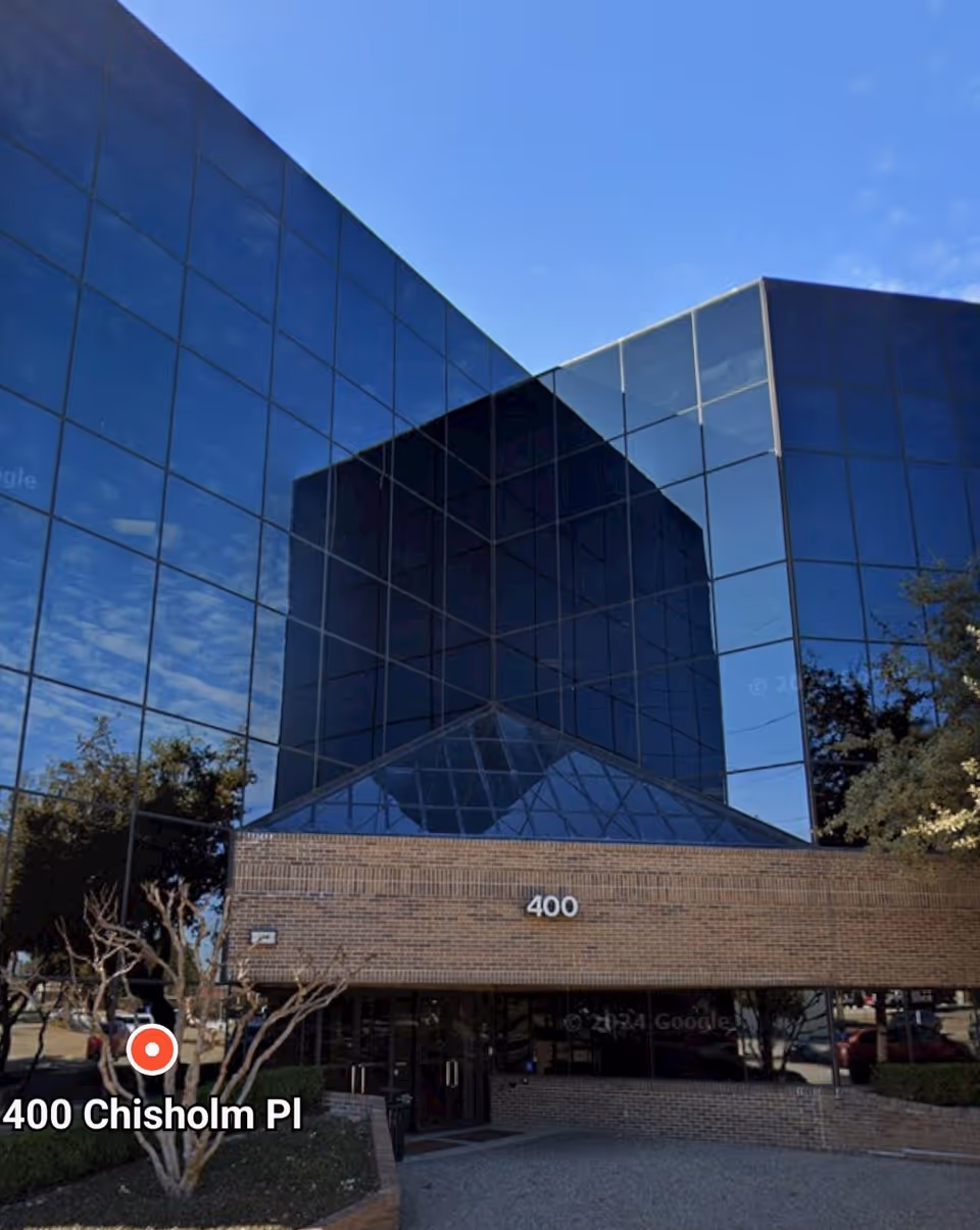 Modern glass-front building with brick base and 400 on facade.