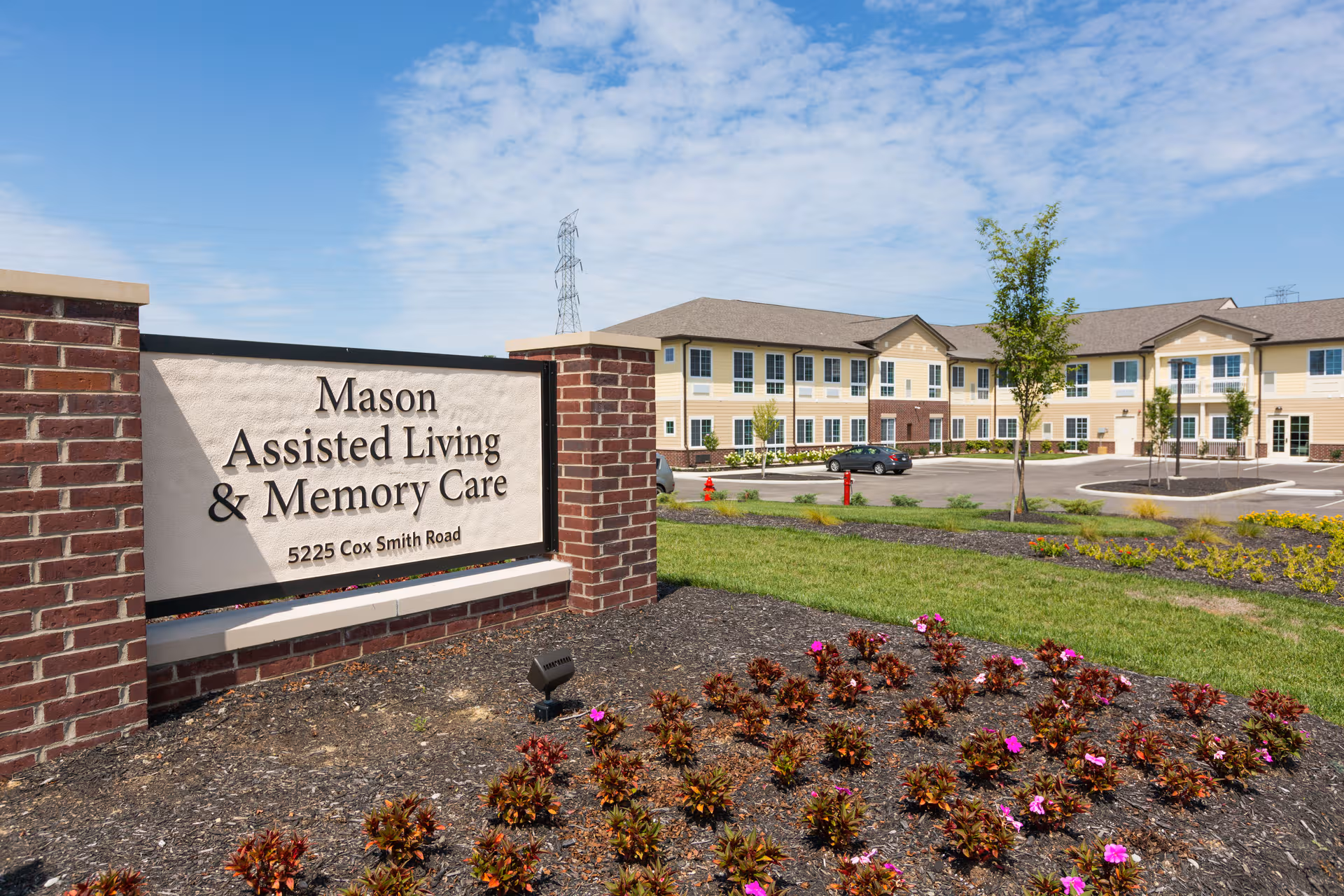 Mason Assisted Living & Memory Care sign in foreground with beige building behind