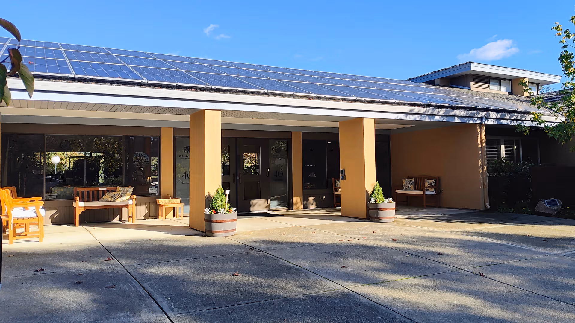 Exterior view of Friends House senior living facility with solar-paneled roof and welcoming entrance