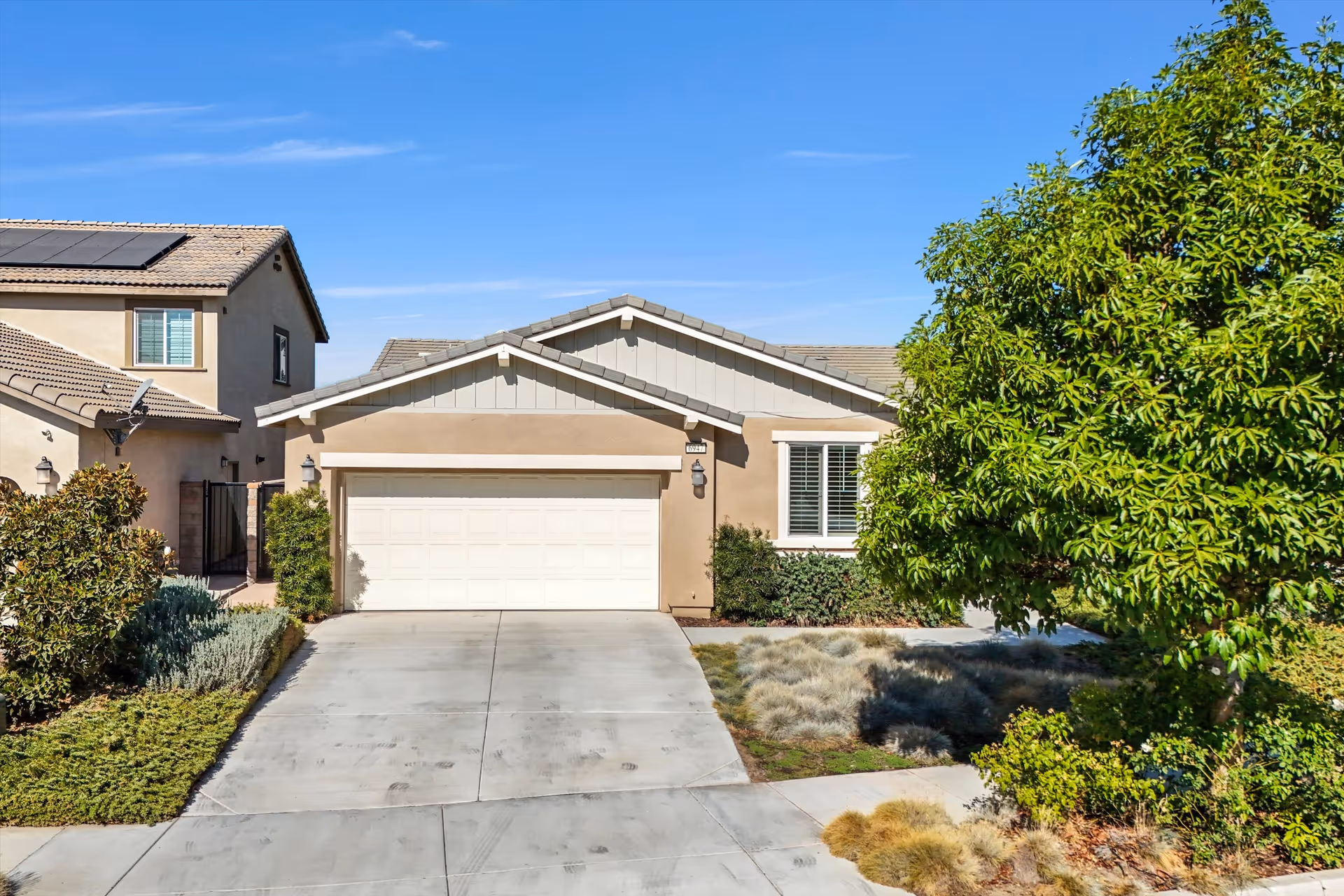 Exterior view of Sunflower Assisted Living at Jurupa Valley with driveway and landscaping.