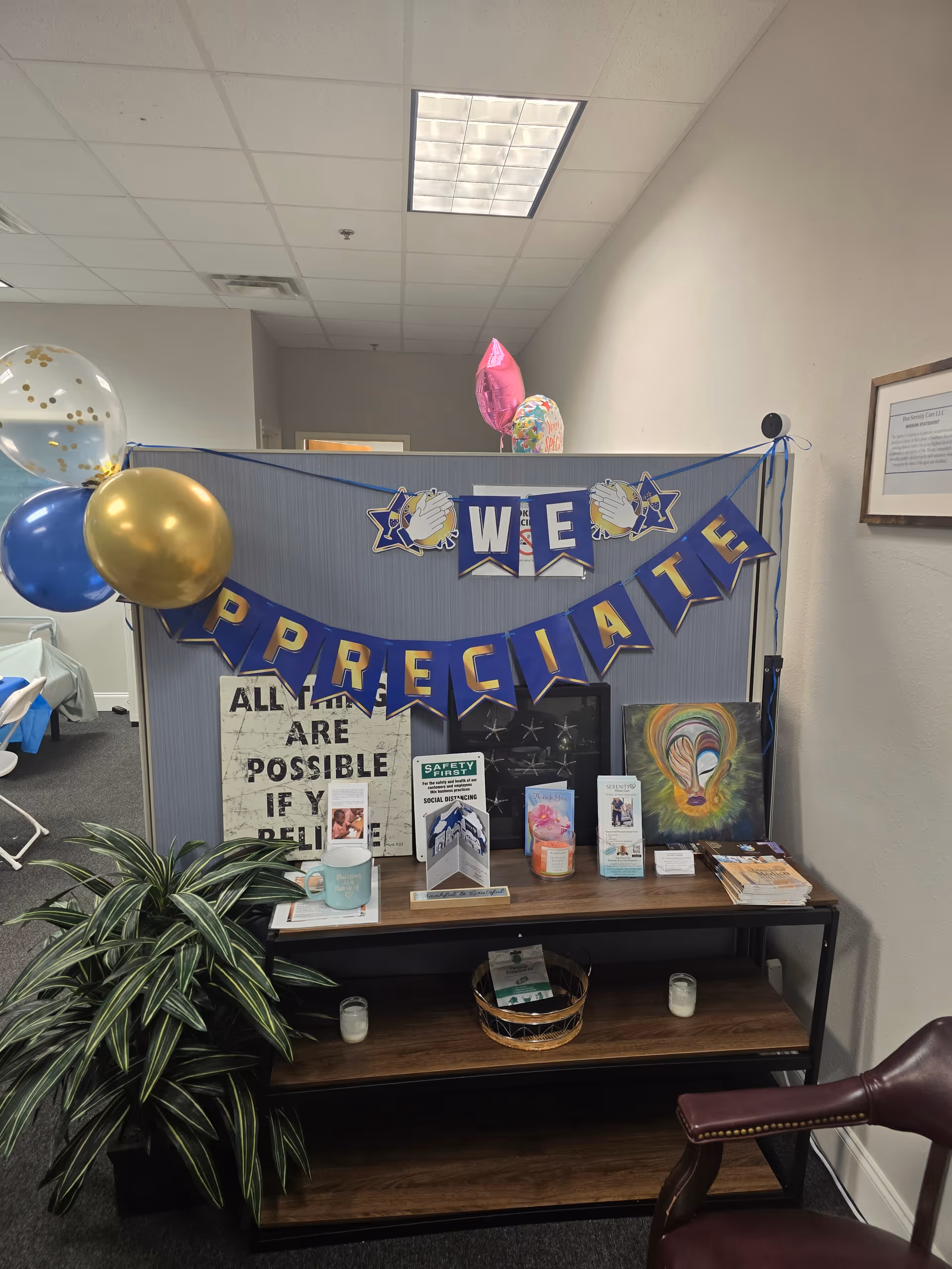 Indoor lounge area with a We Appreciate banner, balloons, and pamphlet display.