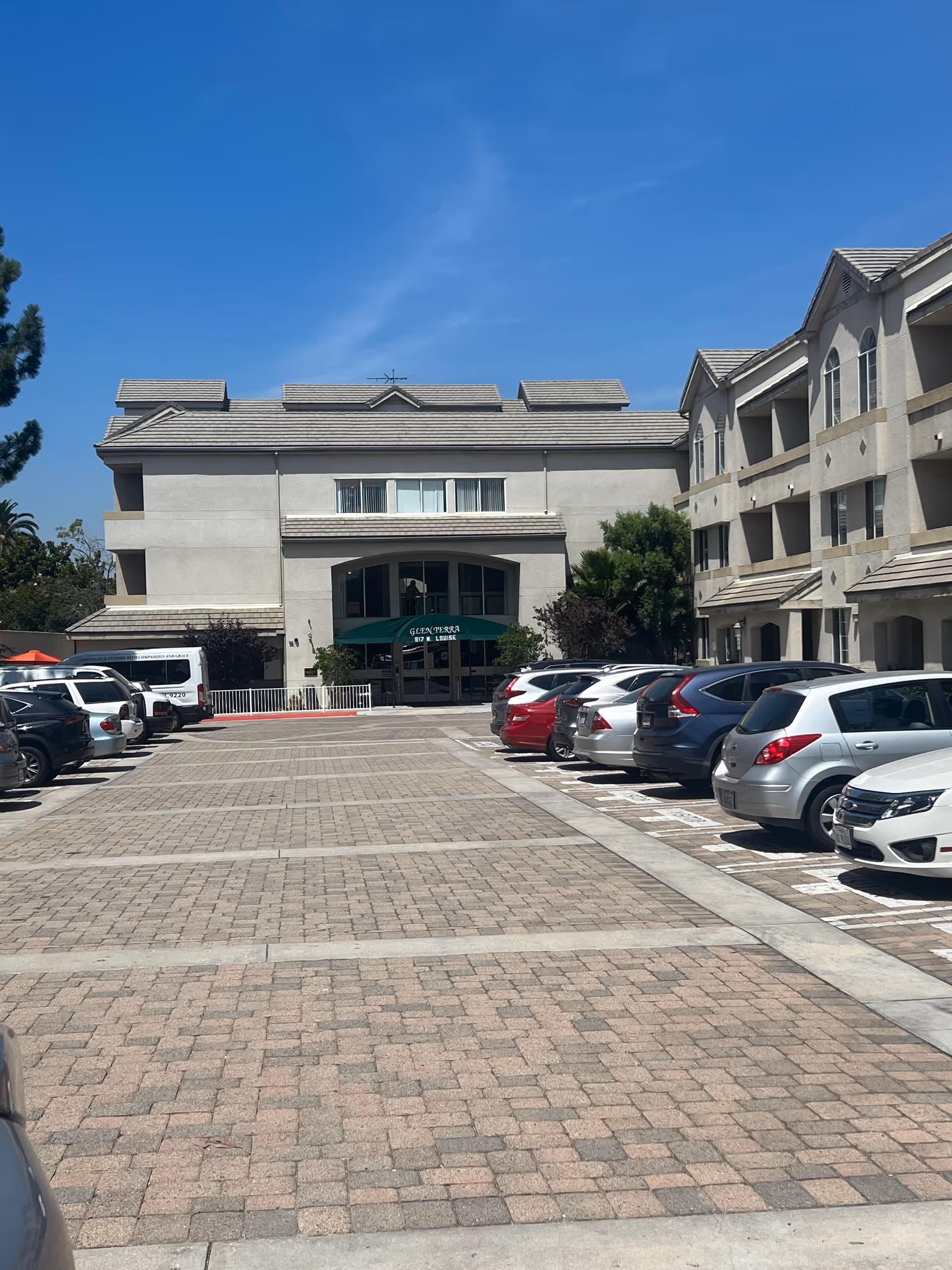 Front exterior view of Glen Terra Assisted Living with a parking lot.