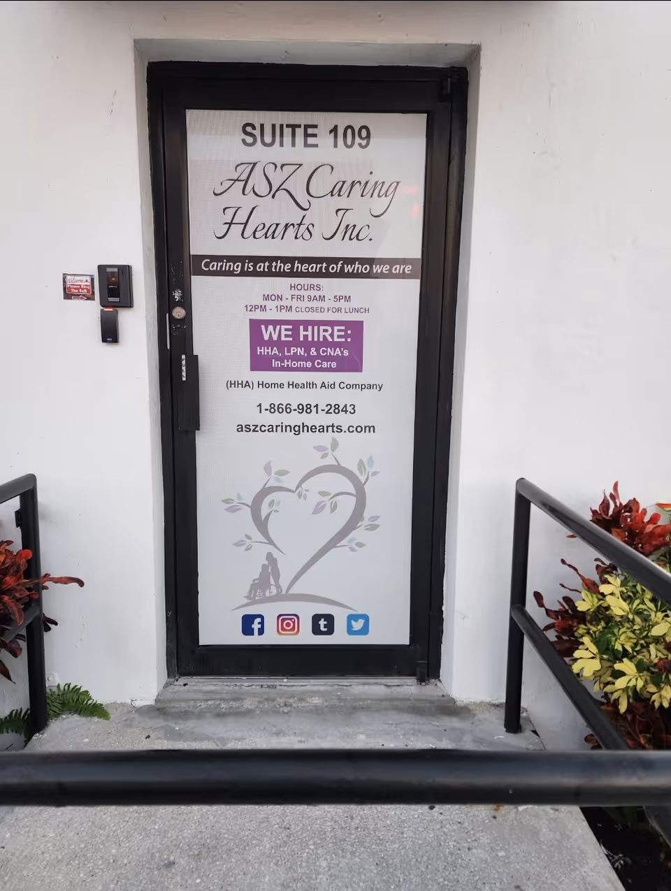 Door to ASZ Caring Hearts Inc. Suite 109 with heart graphic and social icons.
