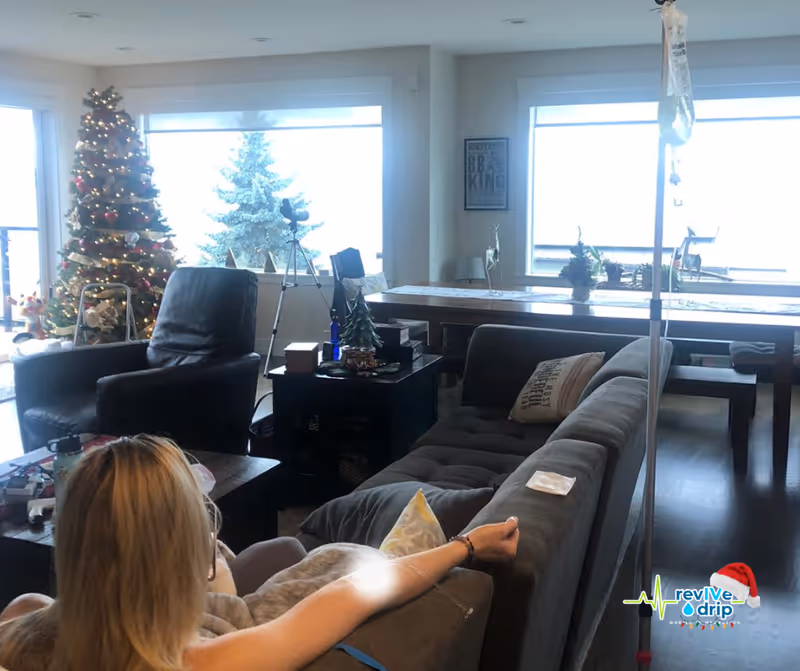 Cozy senior living living room with a Christmas tree, sofa, and bright windows.