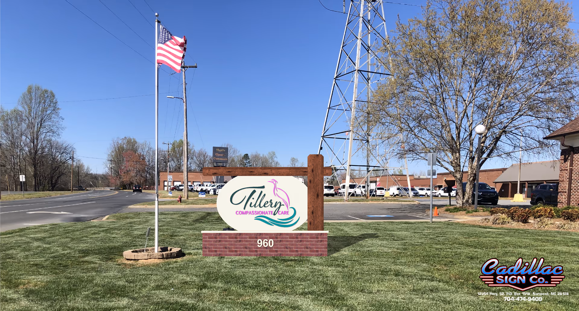 Exterior view of Tillery Compassionate Care sign with parking lot and flag in front.