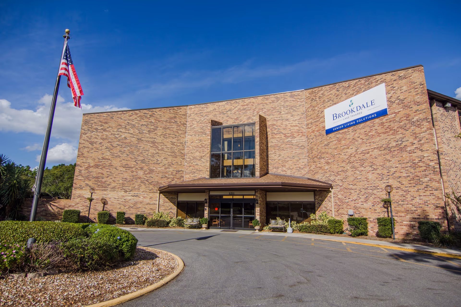 Brick exterior of Brookdale Lake Tavares with entrance and sign.