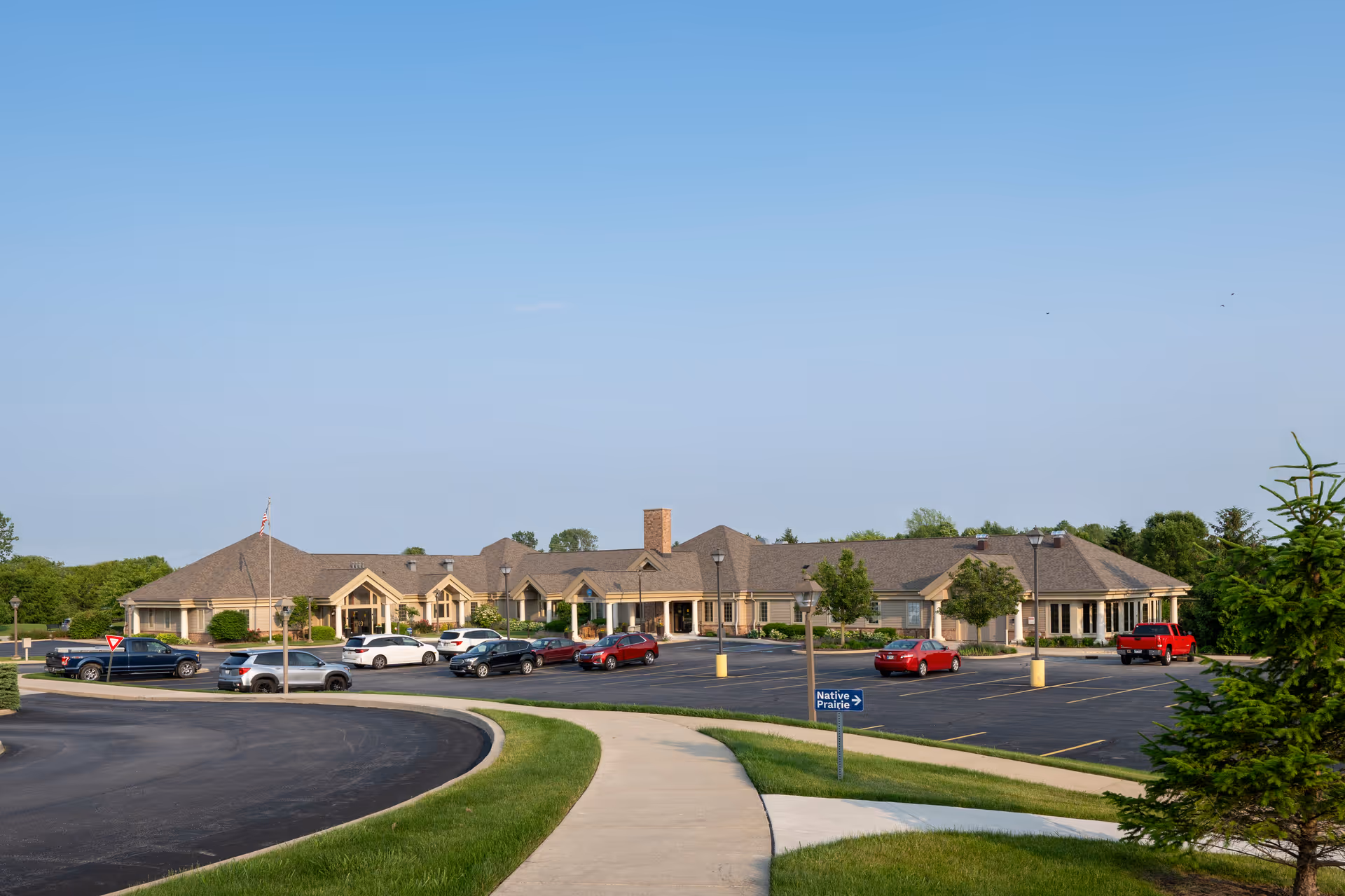 Exterior view of Stillwater Hospice IN, a single-story facility with a large parking lot.