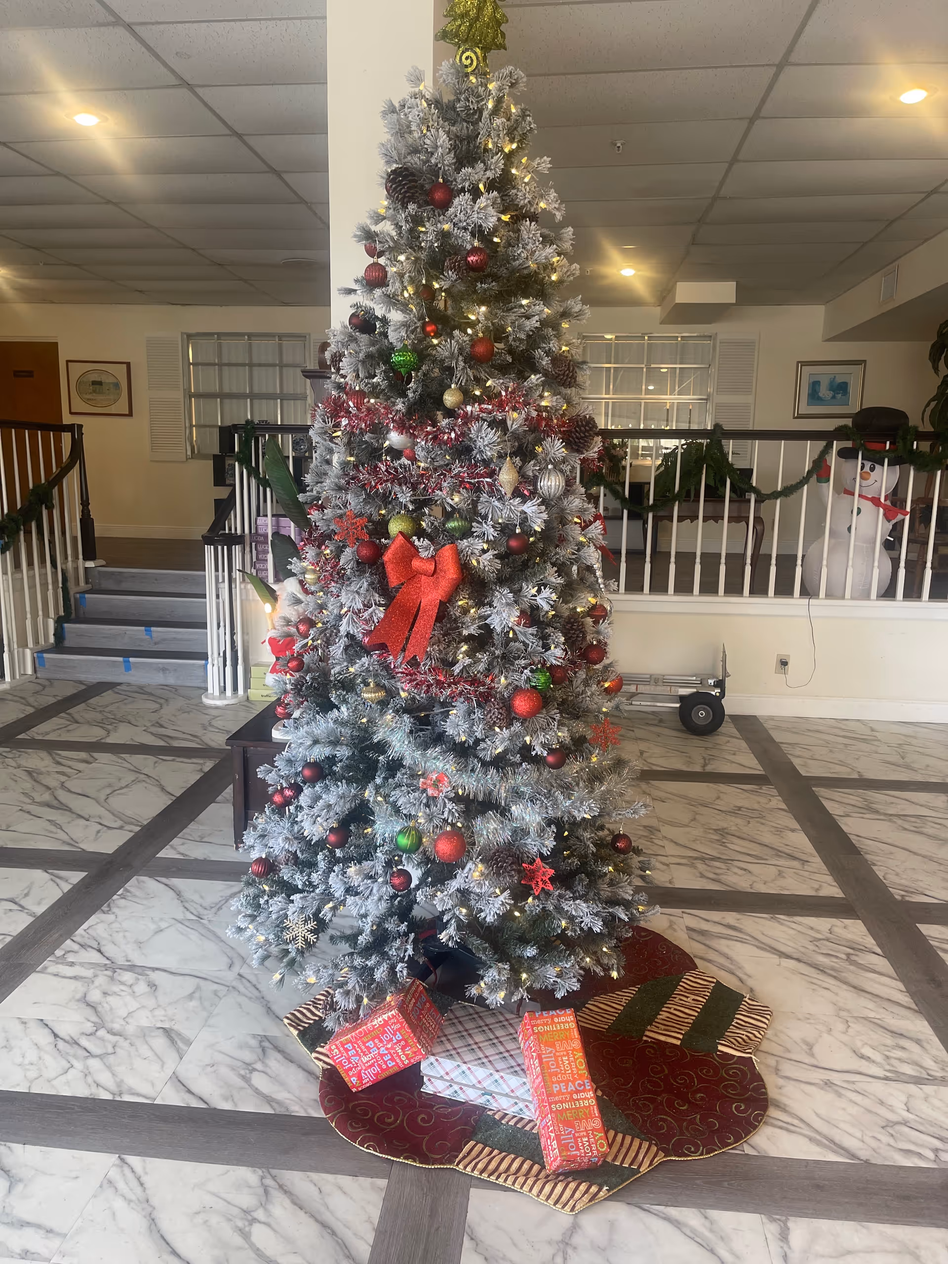 Festive silver Christmas tree in Oasis at Margate lobby with wrapped gifts
