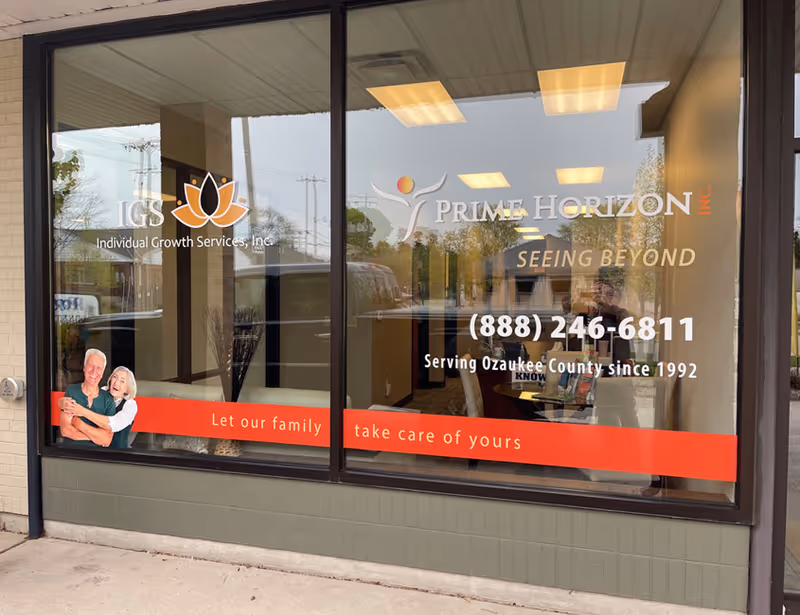 Glass storefront displaying Prime Horizon Inc. signage, contact info, and a red banner for senior living.