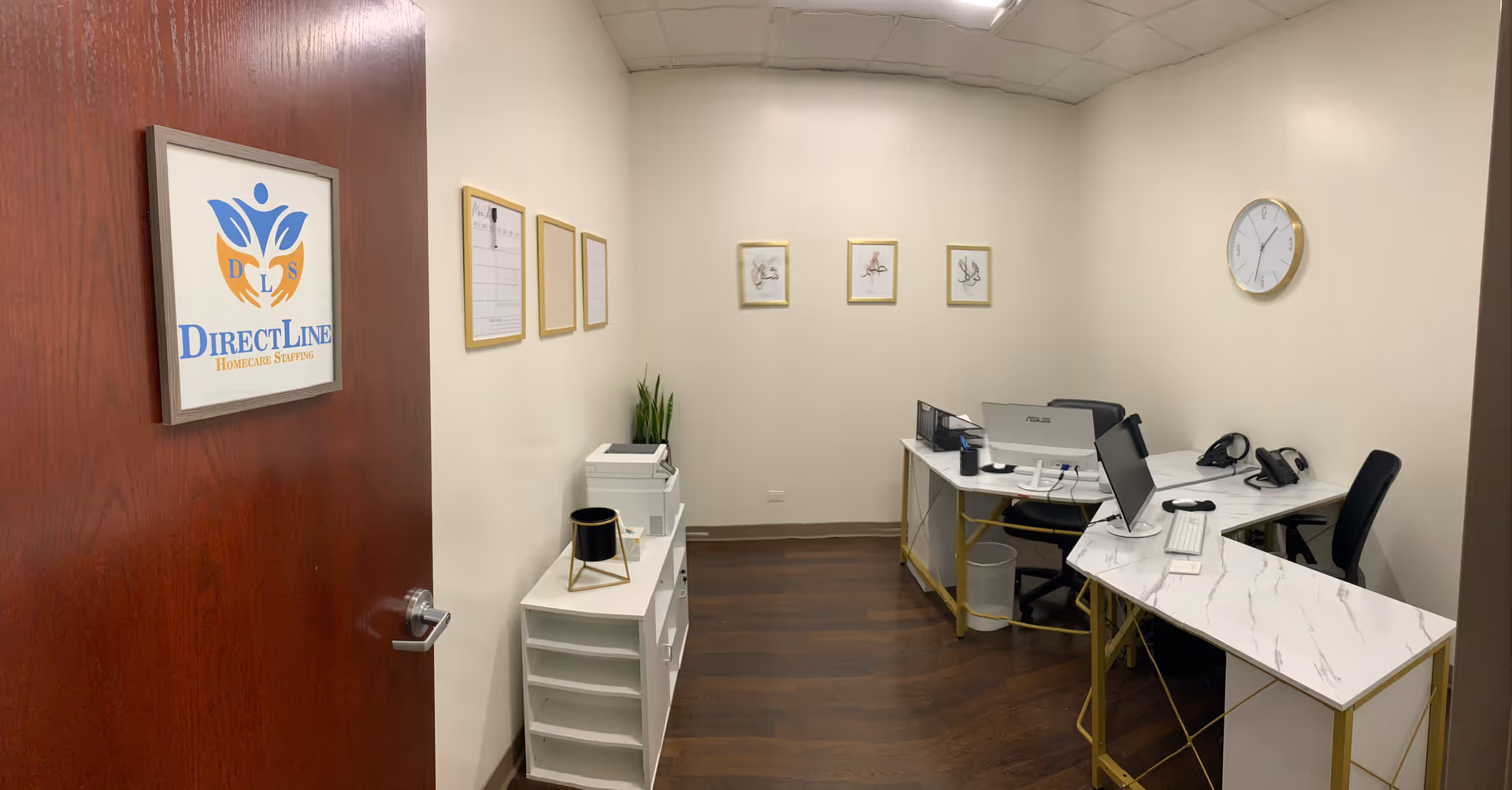 A small reception/office area with desks, computers, clocks, and Direct Line signage