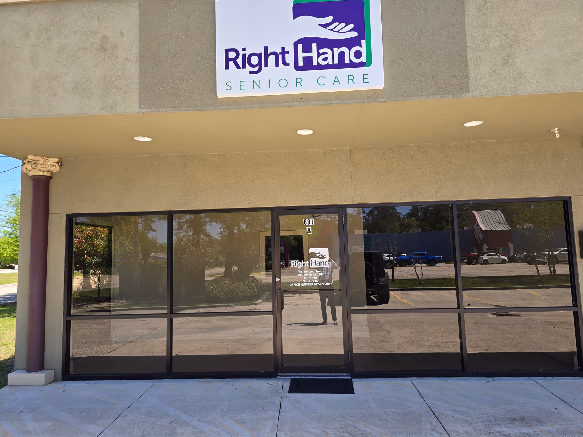 Exterior view of Right Hand Senior Care facility with glass doors and a prominent logo sign.