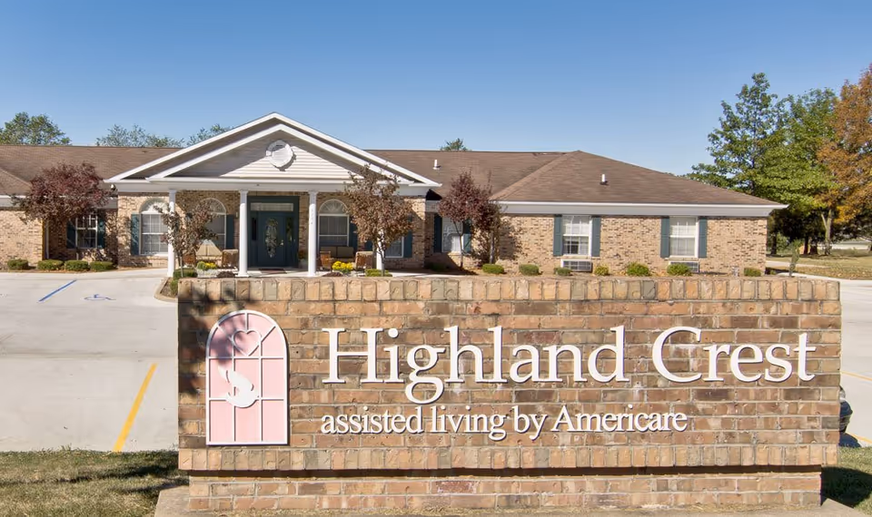 Exterior front view of Highland Crest Senior Living with brick sign in foreground.