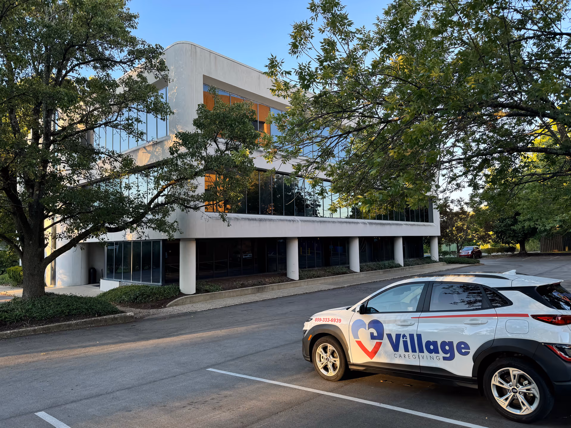 Exterior view of Village Caregiving building with a branded car parked in front