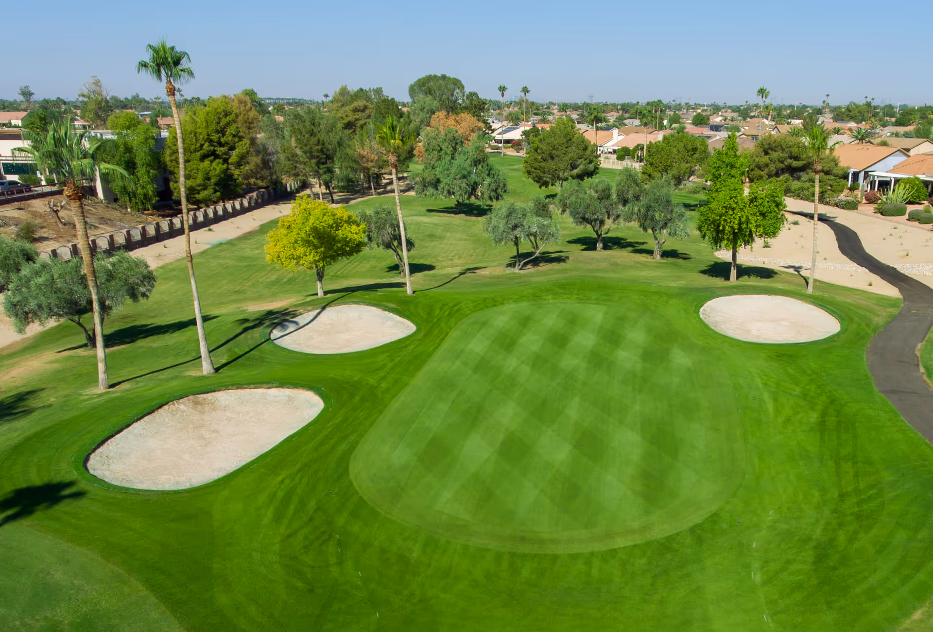 Aerial view of a lush golf course with sand bunkers in Sun City West