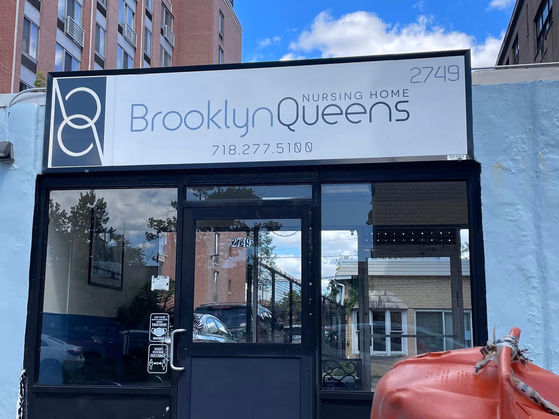 Exterior storefront of Brooklyn Queens Nursing Home with glass doors and signage.