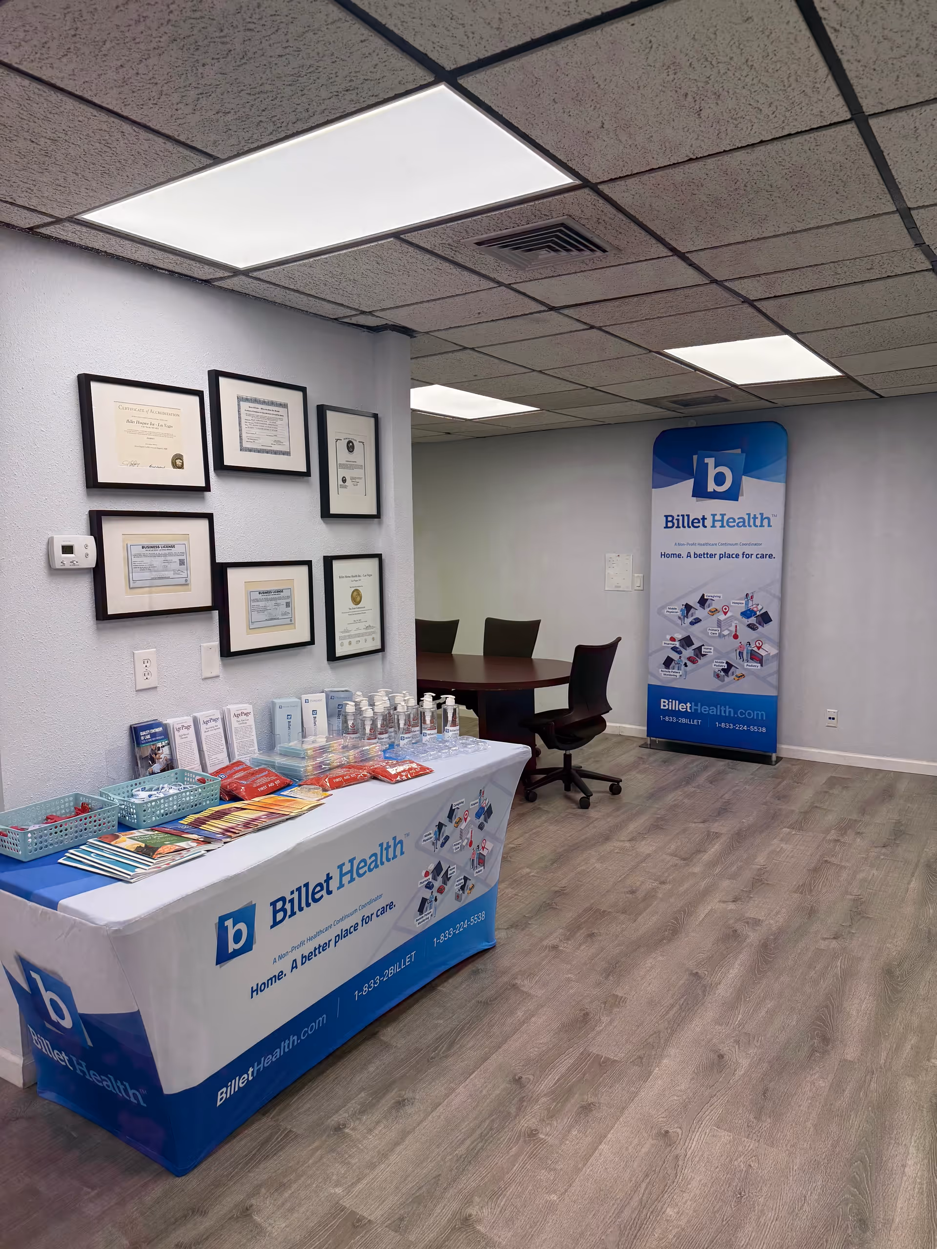 Interior of a Billet Health facility reception area with a branded table, brochures, and framed certificates.