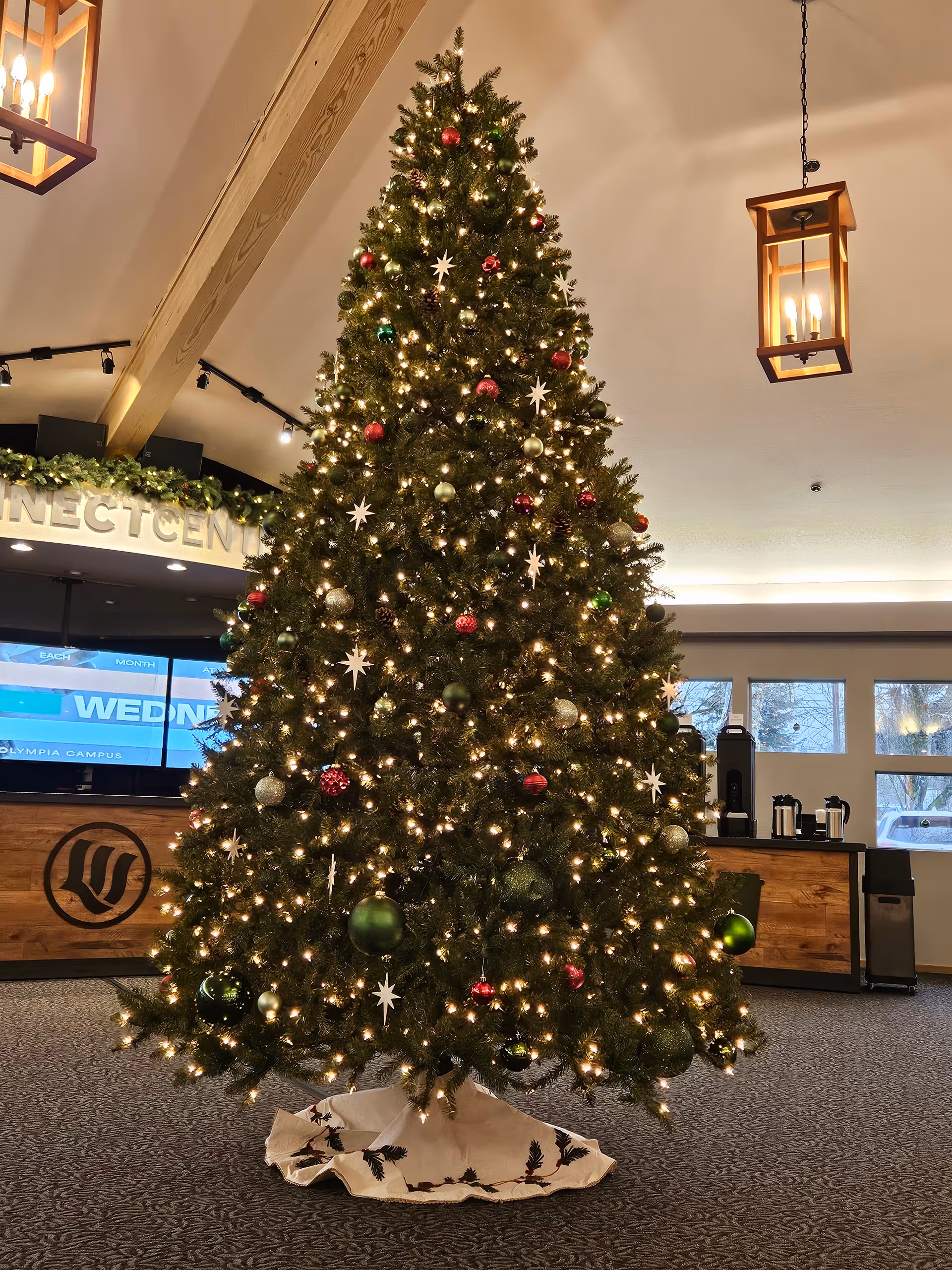 Tall Christmas tree with lights stands in Carna Diaz Adult Family Home lobby.