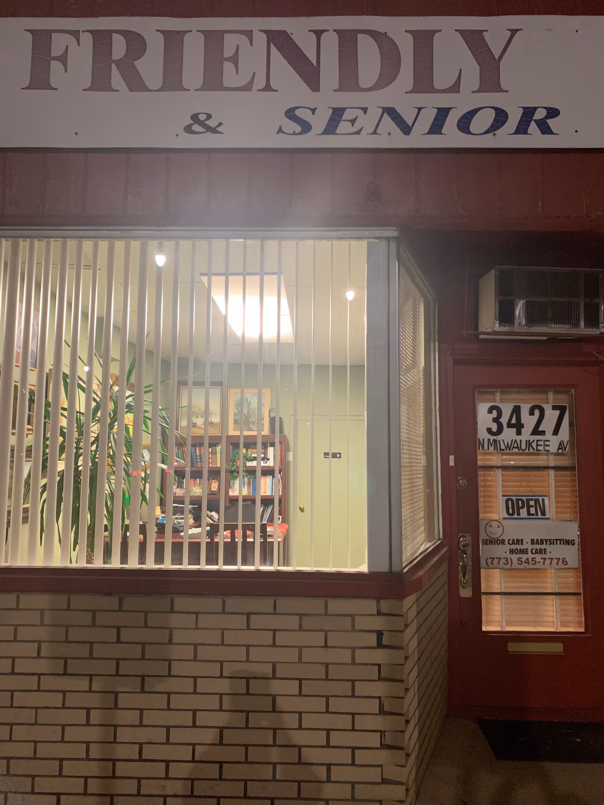 Front of Friendly Home Care building with barred window and open door