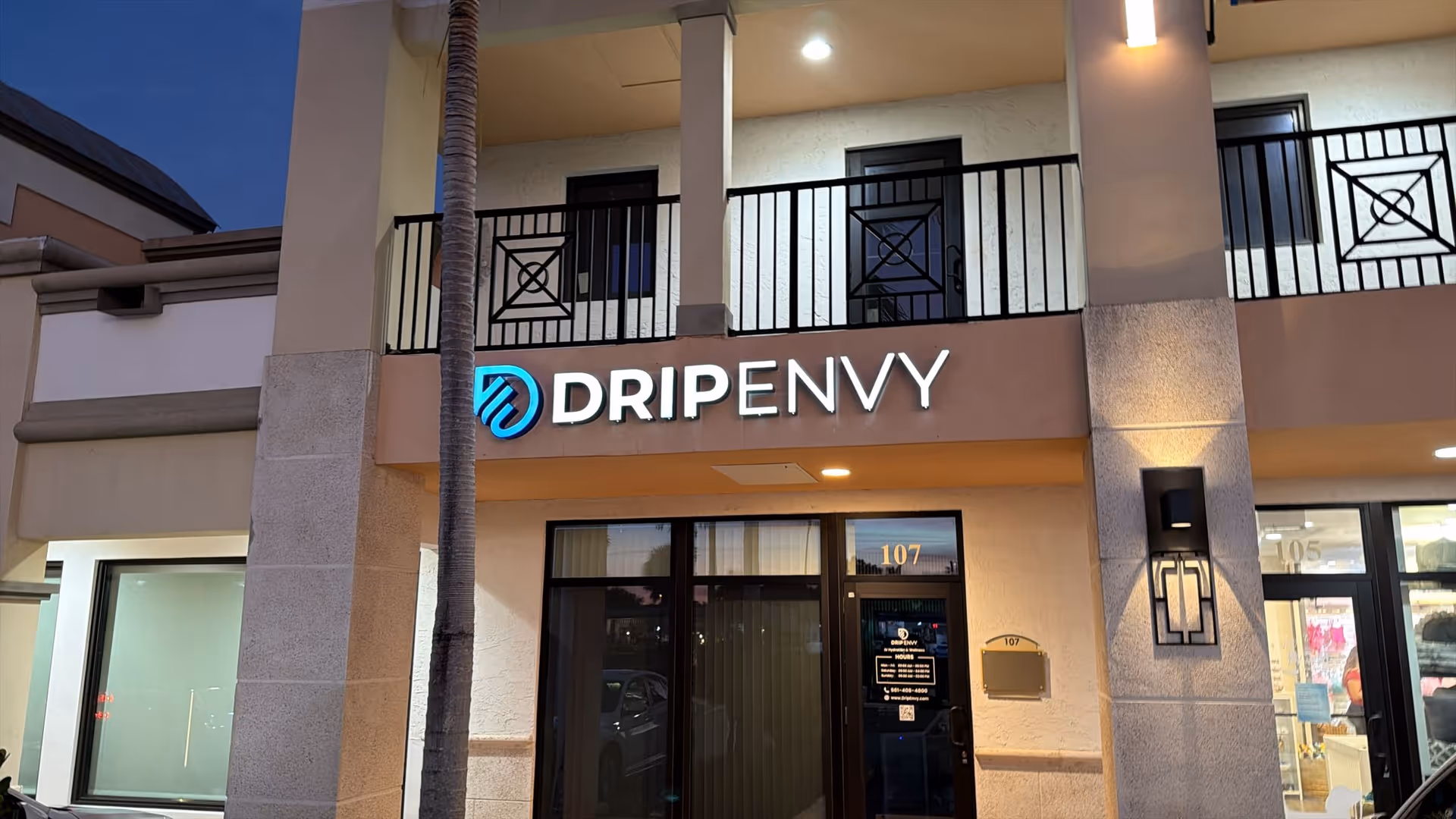 Exterior view of a storefront-style building with DRIPENVY sign and glass entrance.