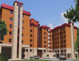 Exterior view of a multi-story brick assisted living facility with red accents.