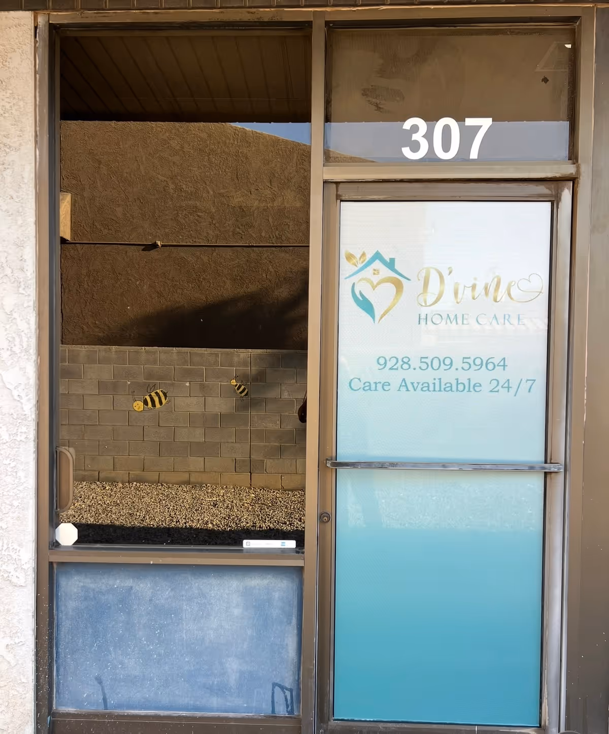 Front entrance with the D'vine Home Care logo on a glass door and the number 307.