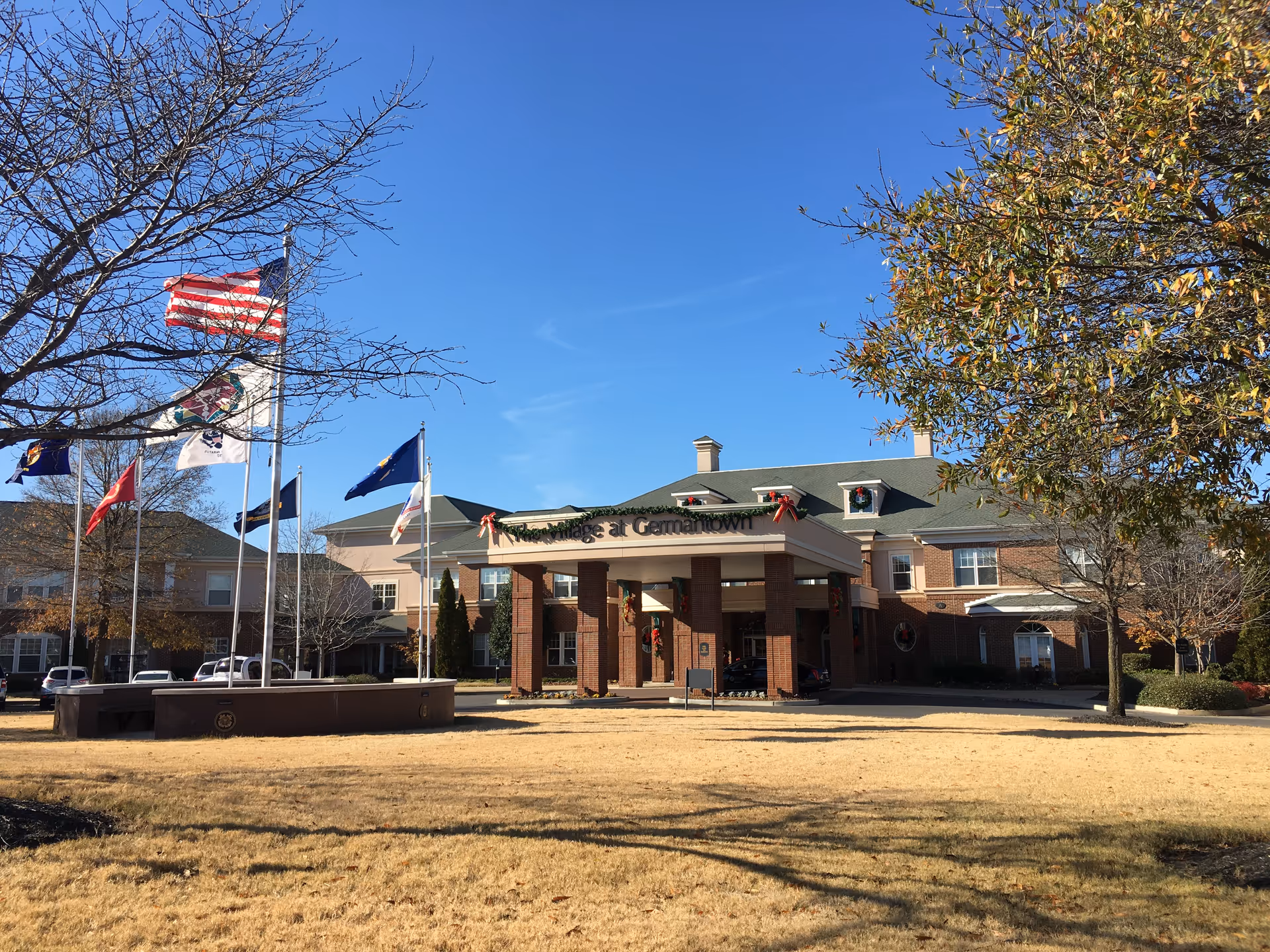 Exterior view of The Village at Germantown entrance with flags and clear blue sky