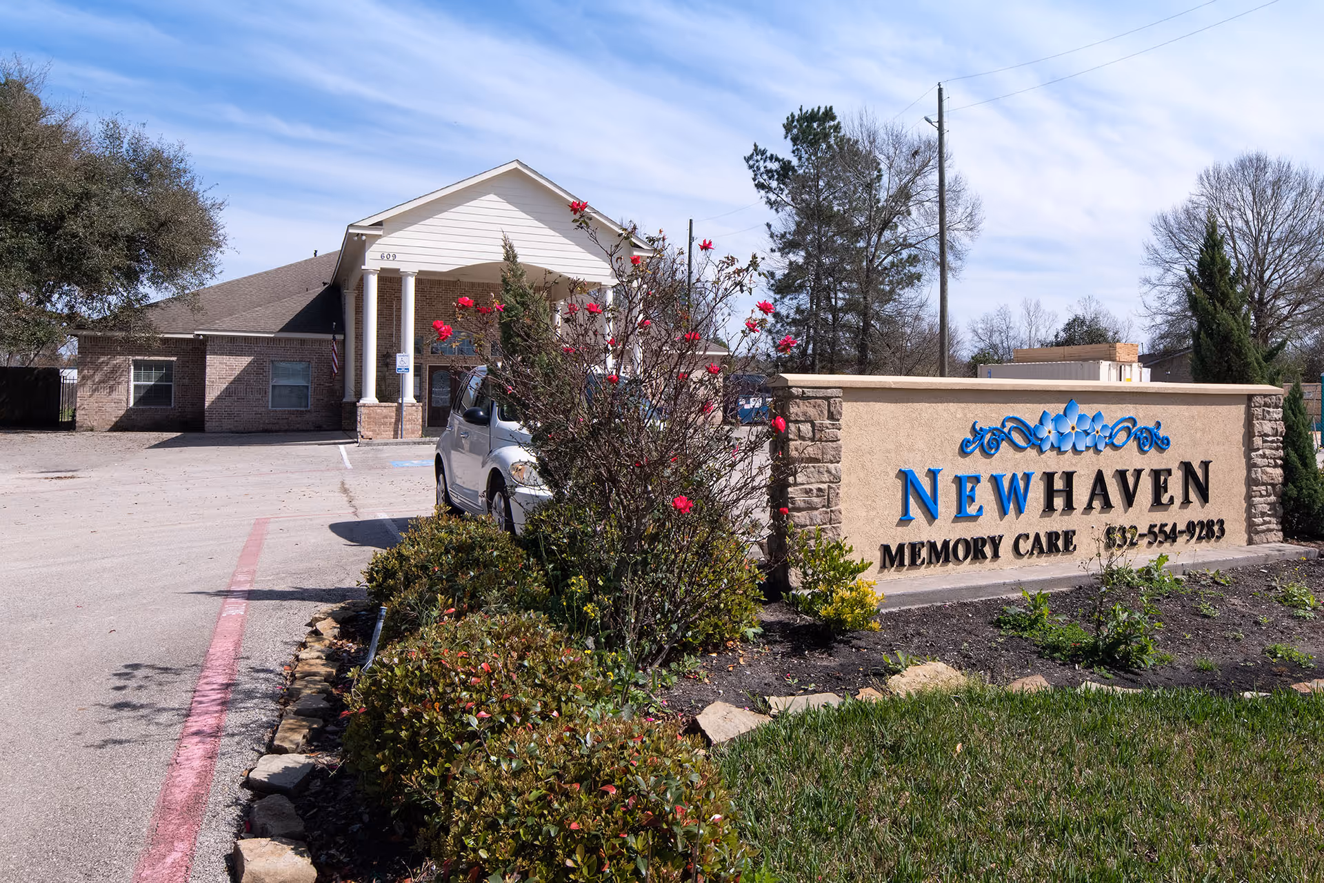 Exterior of a senior care facility with a stone sign reading New Haven Memory Care.