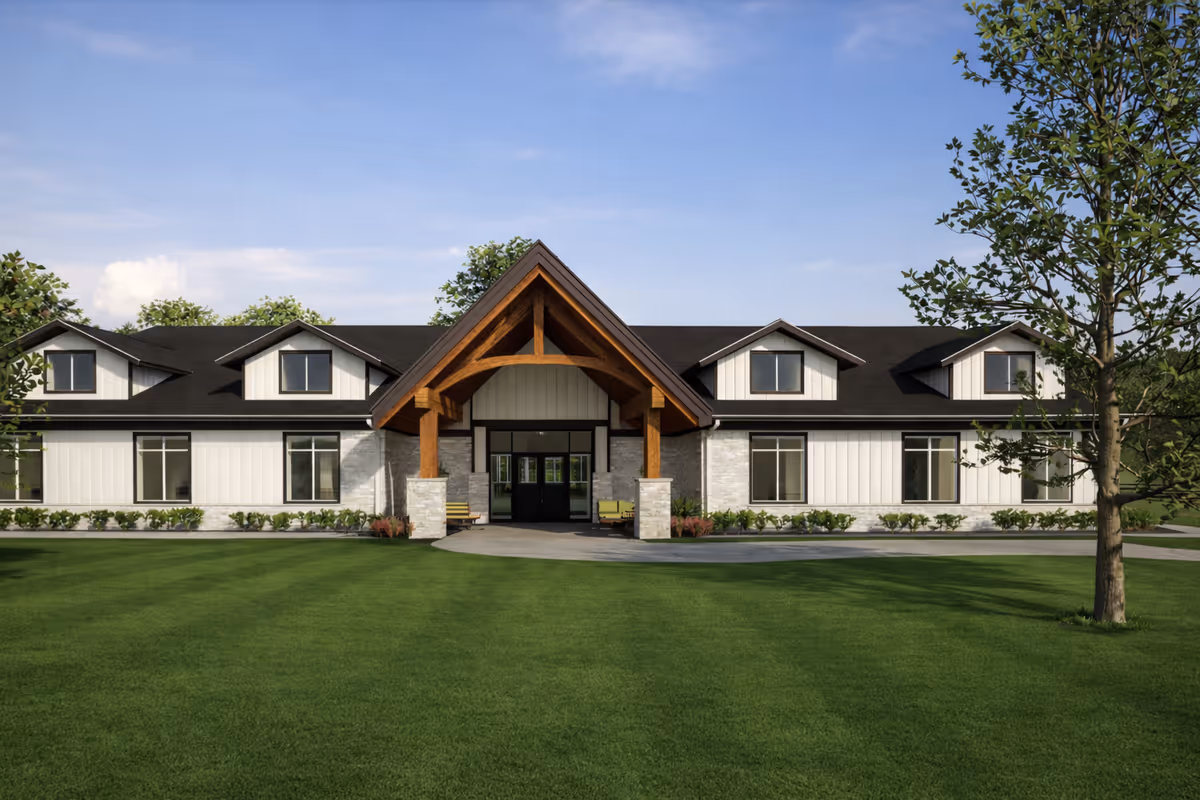 A large modern senior living facility exterior with a central entrance and manicured lawn.