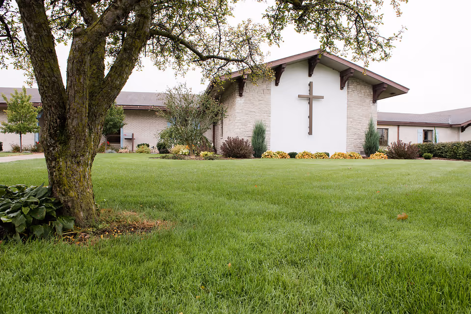 Wellspring Frankenmuth Hospice building with a cross on the front wall.