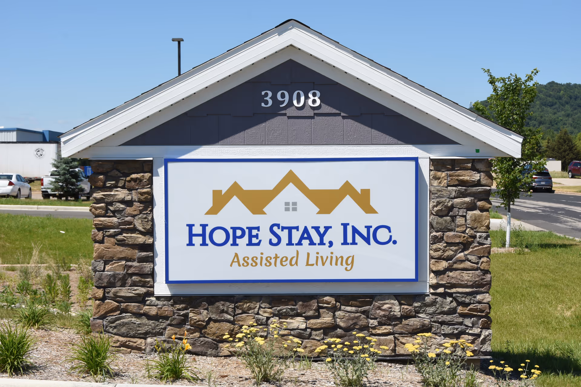 Stone-front sign with Hope Stay, Inc. Assisted Living logo and address 3908.