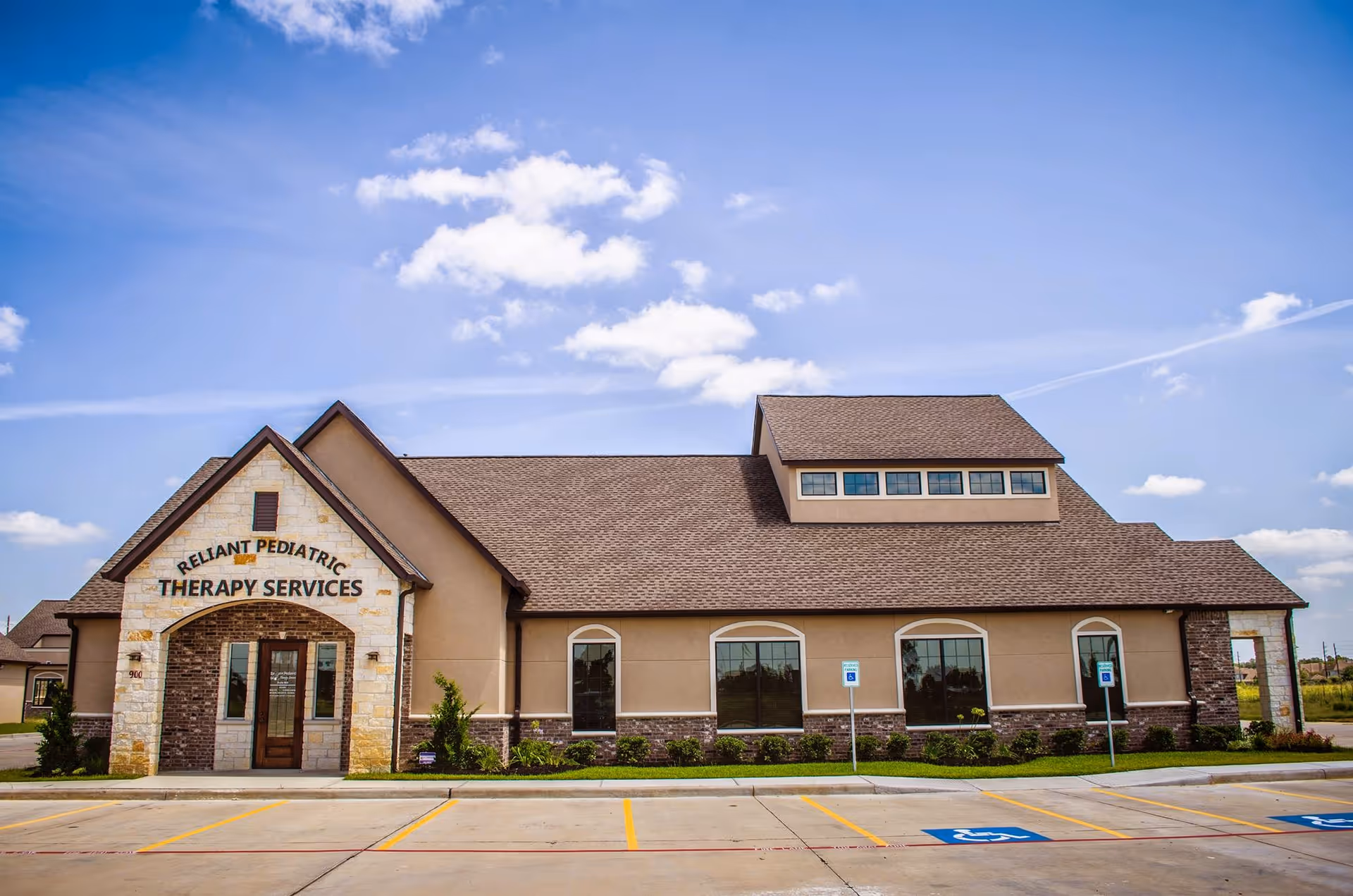 A modern single-story building with Reliant Pediatric Therapy Services signage and a parking lot.