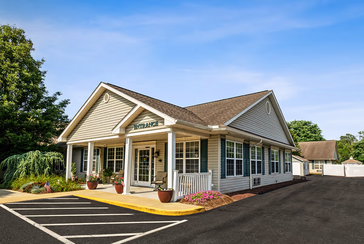 Exterior view of Maidencreek Place senior living facility front entrance with parking.