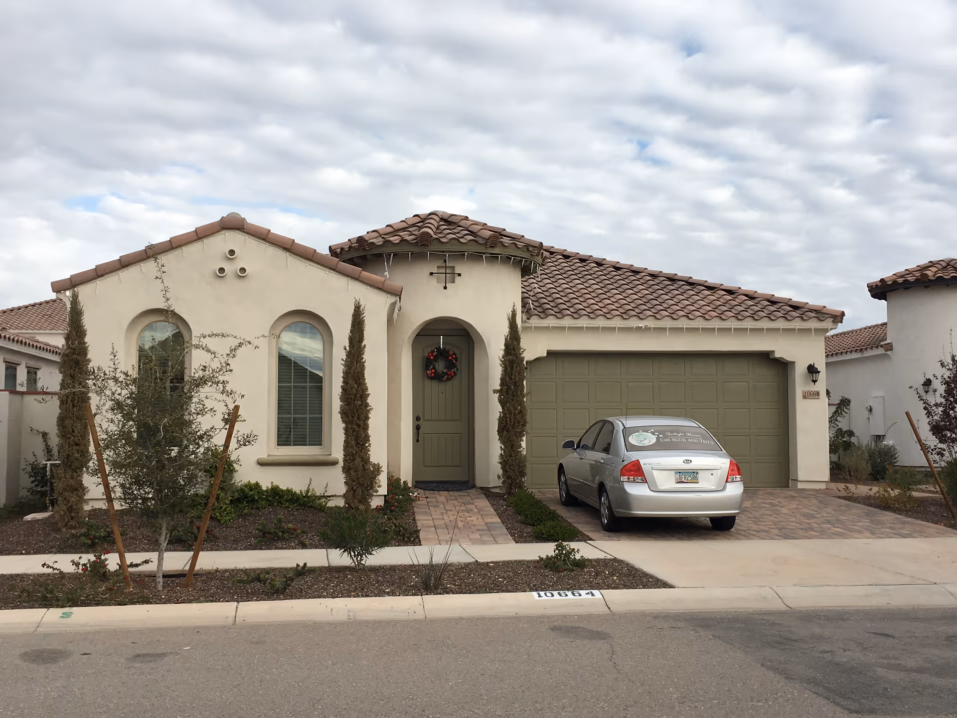 Front exterior of Twilight Haven Mesa with arched windows and a parked car.