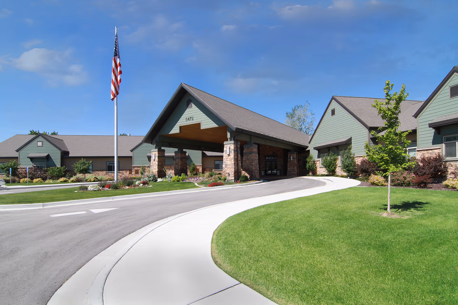 Exterior view of Legacy Village of Taylorsville with curved driveway and flagpole.