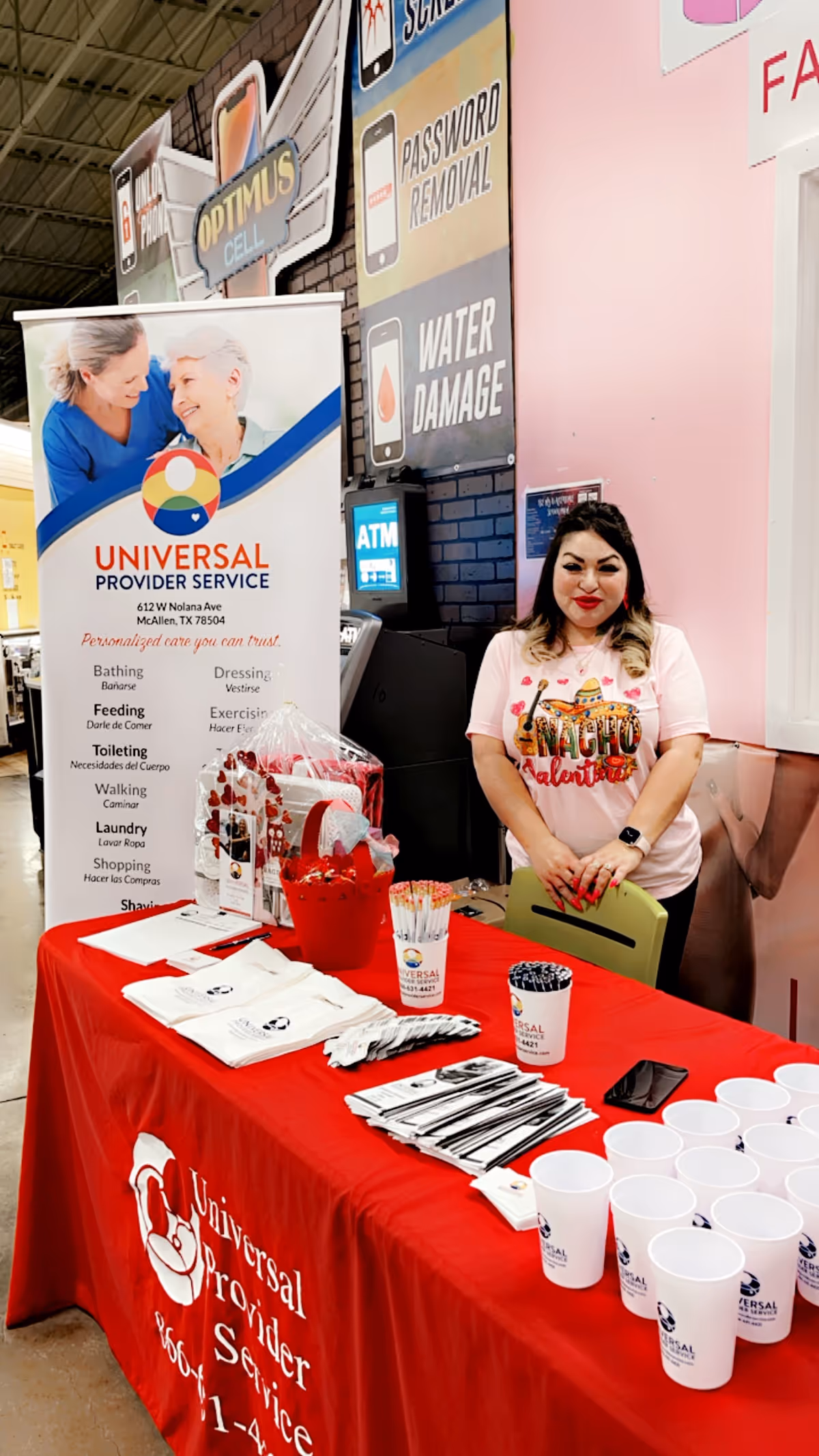 A Universal Provider Service booth with a smiling staff member at a red table.