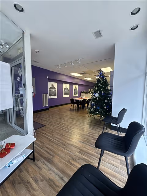 Interior lobby at CareChoice Homecare with purple wall, Christmas tree, and seating.