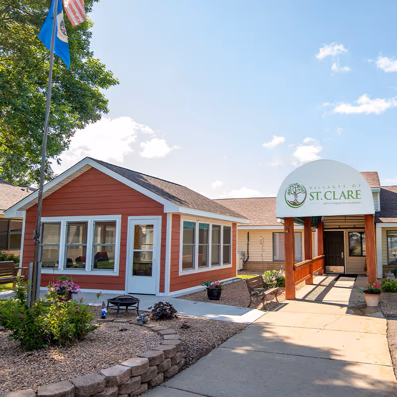 Exterior view of St. Clare senior living facility with entrance canopy.