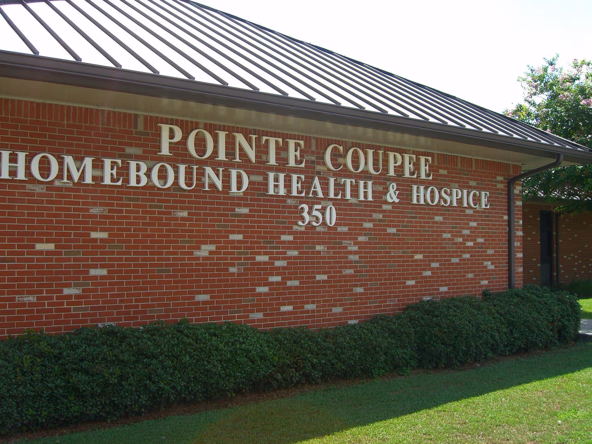 Brick exterior wall of Pointe Coupee Homebound Health & Hospice building.