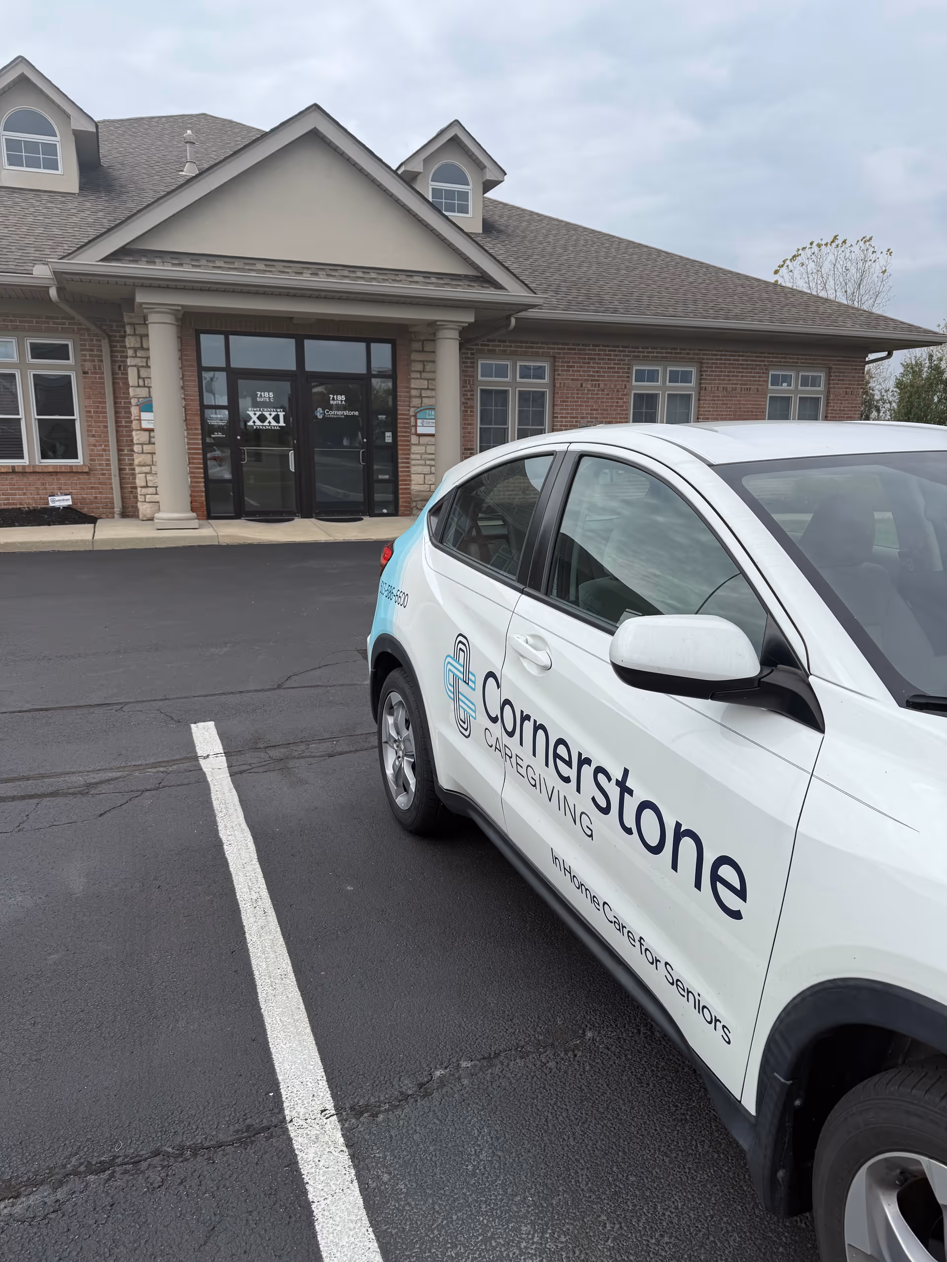 Exterior of Cornerstone Caregiving facility with a branded service vehicle parked in front.