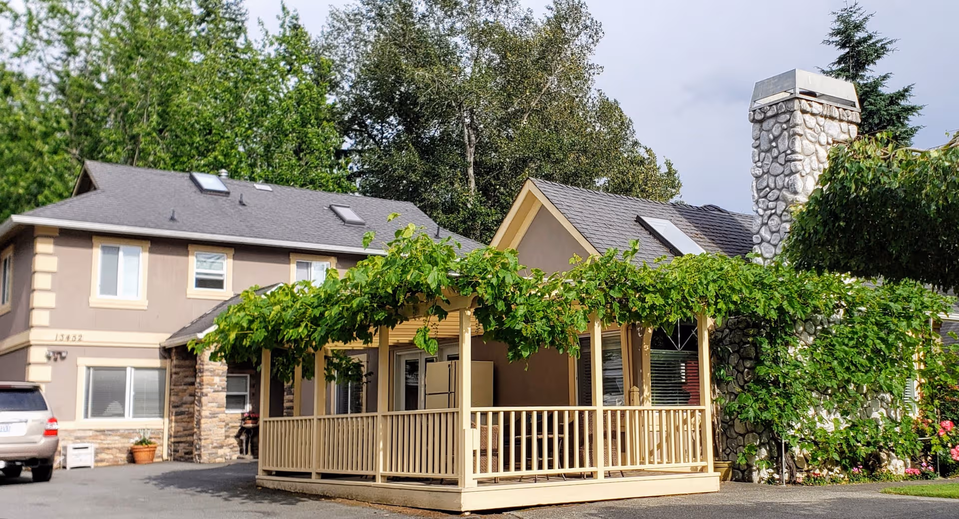 Exterior view of Evergreen Manor Senior Care with vine-covered porch and stone chimney.