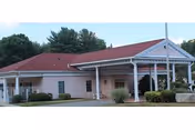 Exterior view of Autumn Lake Healthcare at Bucks Hill with a covered entrance and landscaping.