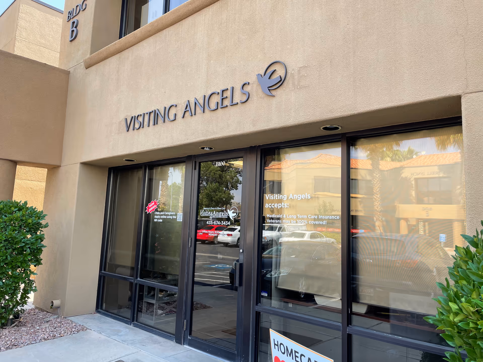 Entrance of Visiting Angels Senior Home Care facility with glass doors and beige stucco exterior