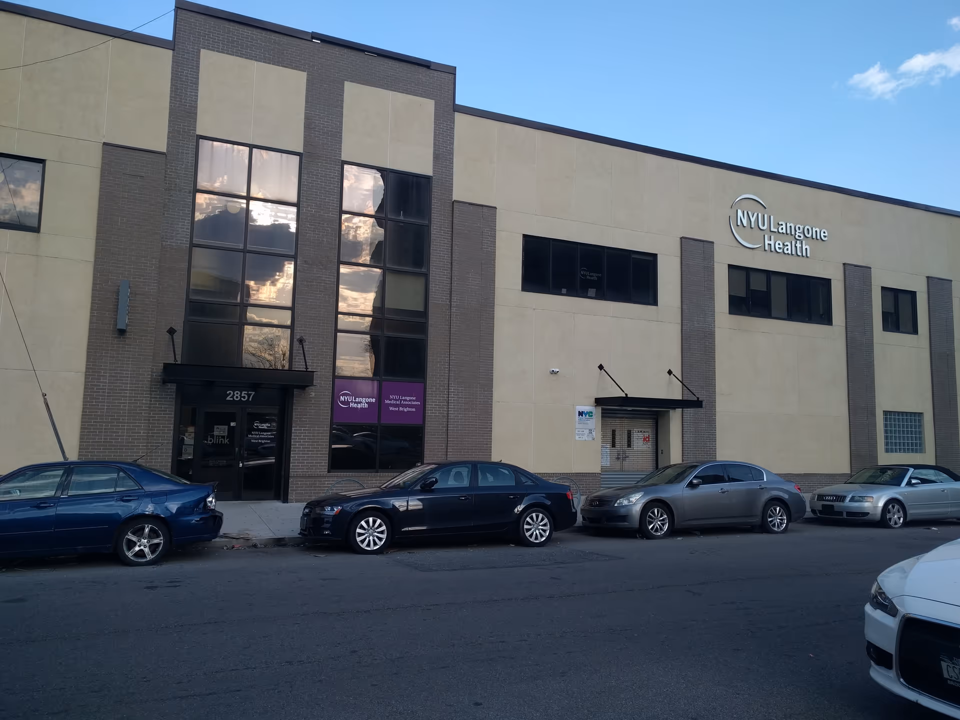 Exterior view of NYU Langone Medical Associates—West Brighton with parked cars in front.