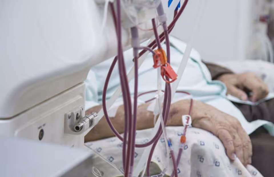 Close up view of medical tubing connected to a patient in a hospital bed.