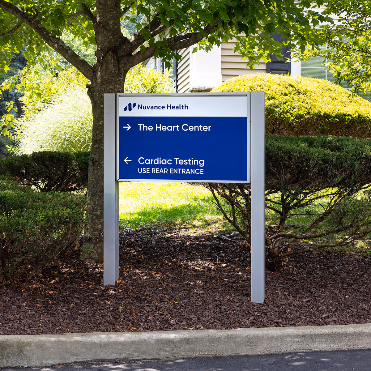 An outdoor sign for Nuvance Health The Heart Center directing to Cardiac Testing.