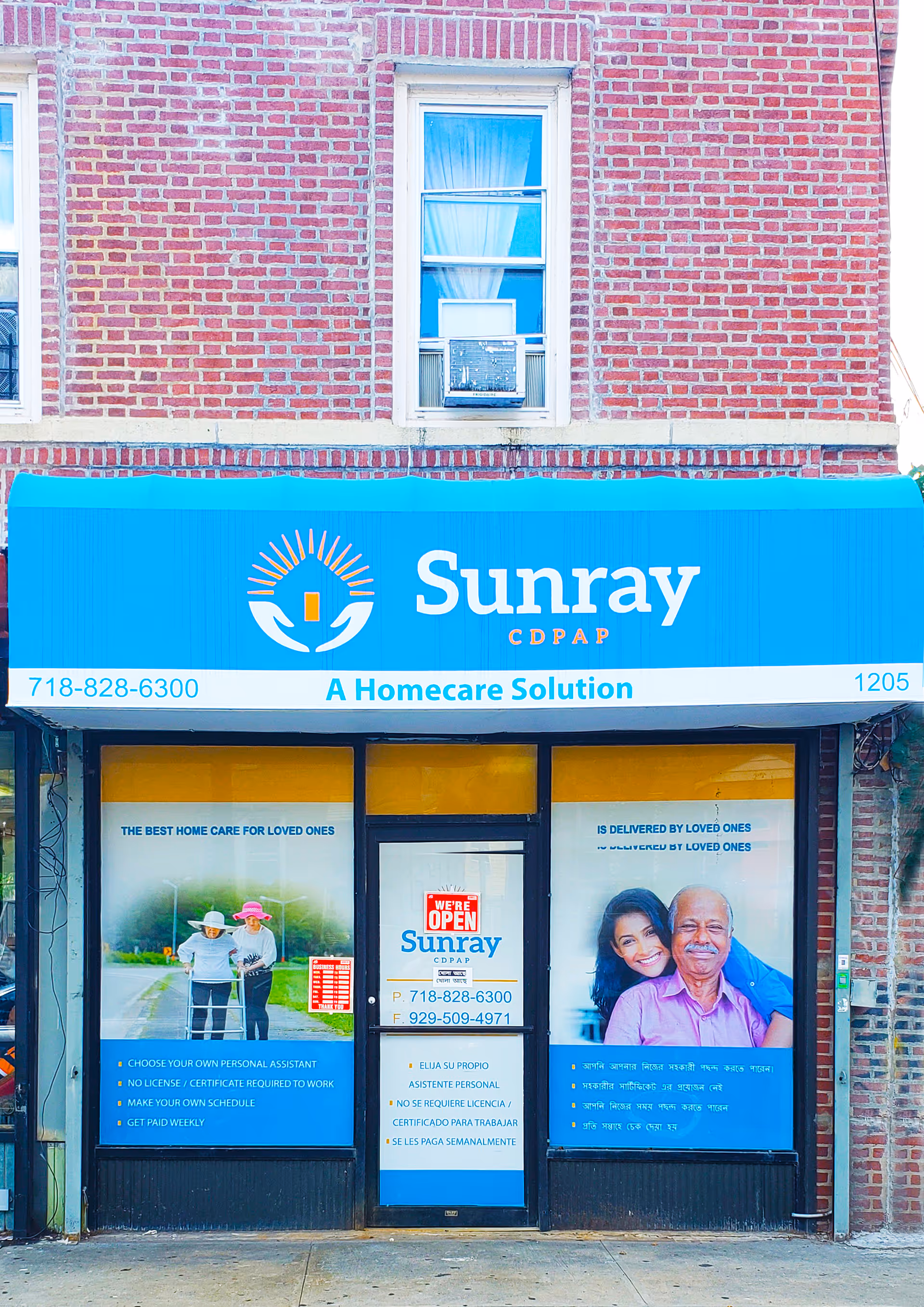 Blue Sunray CDPAP storefront sign on brick building with window posters