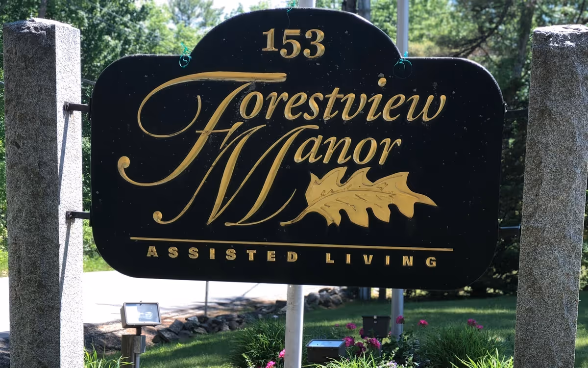 Large Forestview Manor sign reads Forestview Manor Assisted Living with stone posts and greenery.