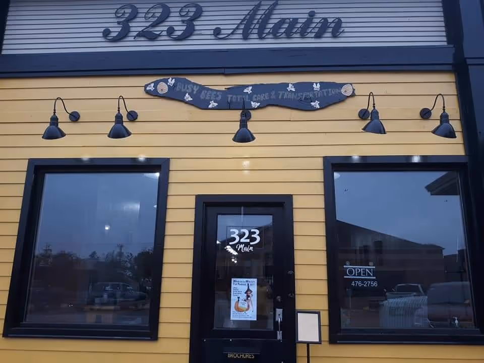Yellow storefront with black-framed windows and Busy Bees signage.