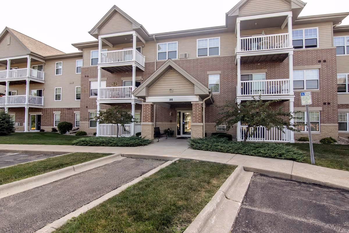 Frost Woods I and II building exterior with balconies and a covered entrance.
