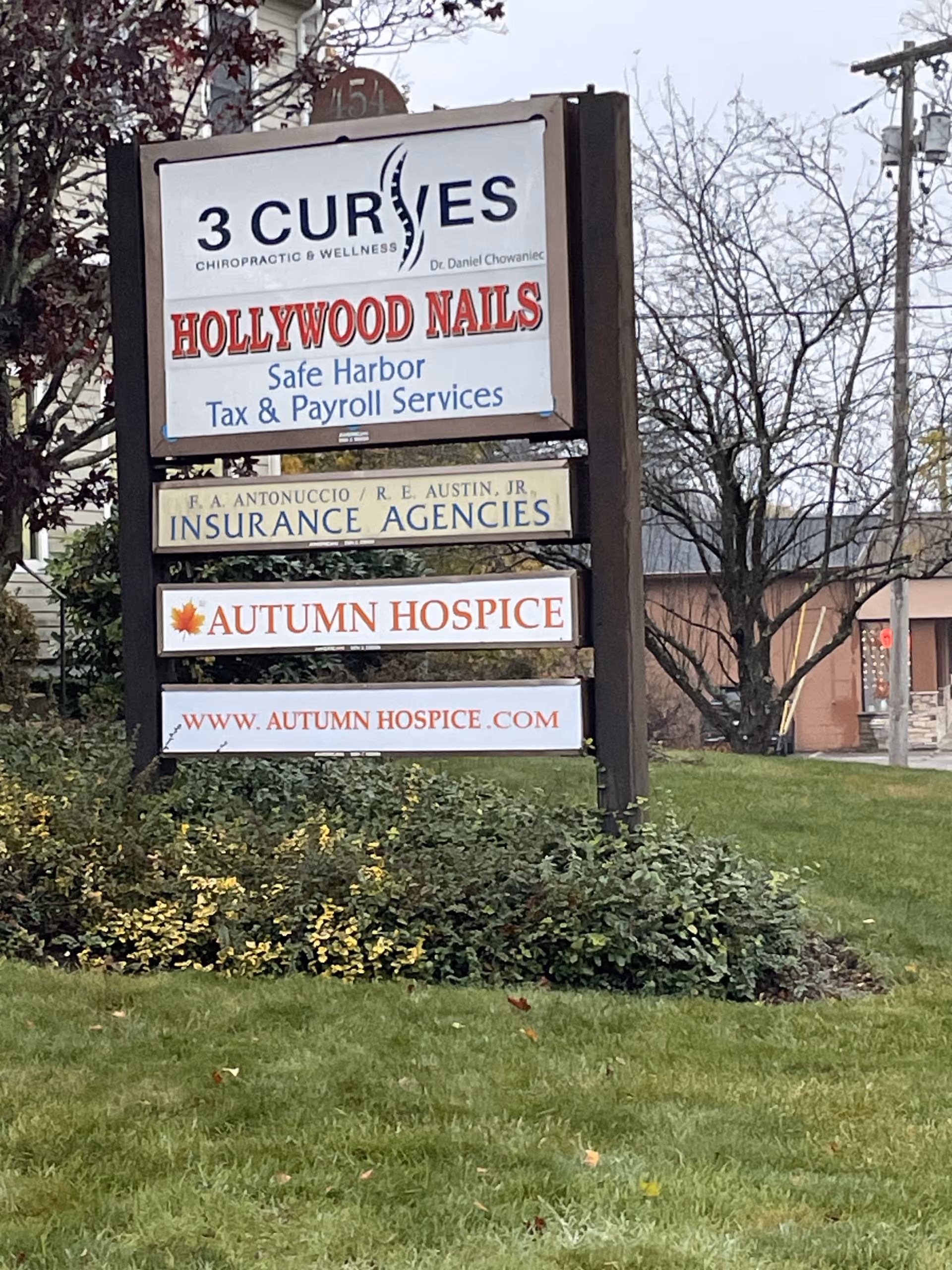 Outdoor sign display advertising Autumn Hospice among other business signs.